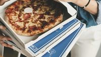 A comandat aproape 300 de pizza în numele altora și a trimis amenințări / Ce riscă acum un tânăr de 23 de ani