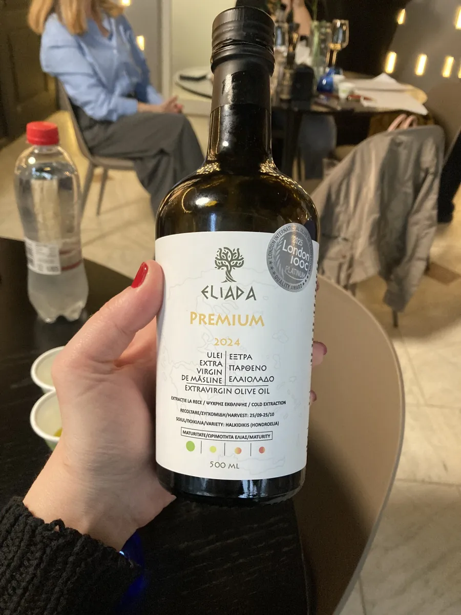 Vedere din fata a sticlei de ulei de măsline extravirgin Eliada Premium, evidențiind designul minimalist și culoarea închisă a sticlei pentru protecția conținutului.