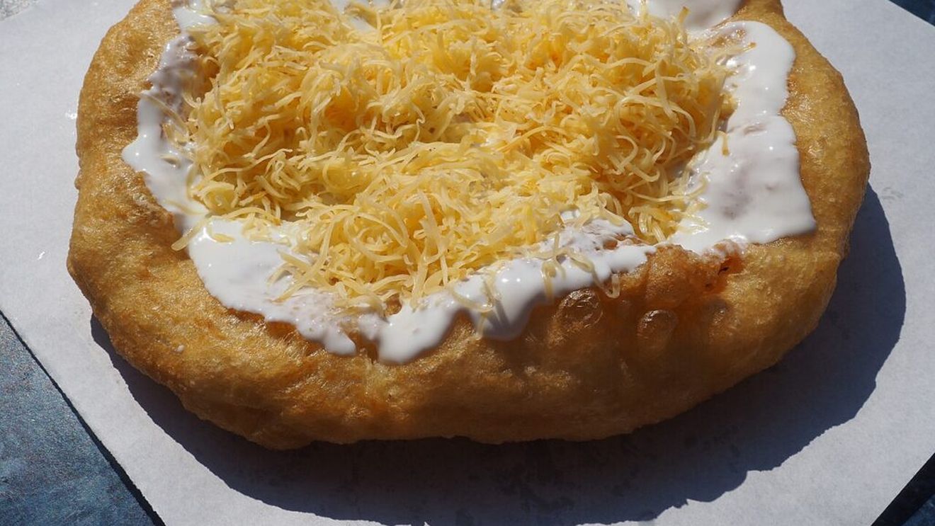 VIDEO | Langoșul, o gustare rapidă, făcută din aluat de pâine, prăjit în ulei încins. Preparatul este marcă înregistrată a bucătăriei maghiare