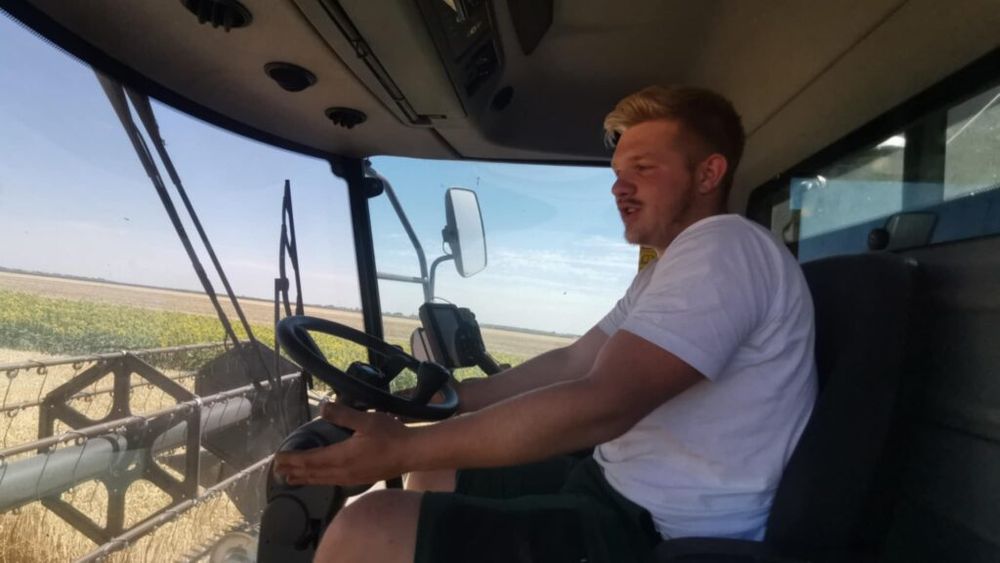 FOTO VIDEO | Student la două facultăți și fermier pe timpul verii/ Max Jakoby, tânărul care conduce combina în Câmpia Banatului